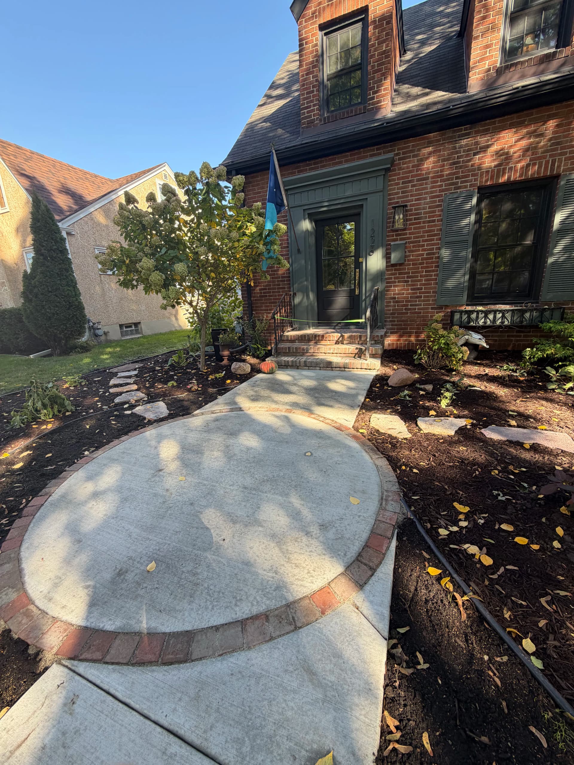 Front Yard Landscape Design with Granite Patio and Brick Edging image