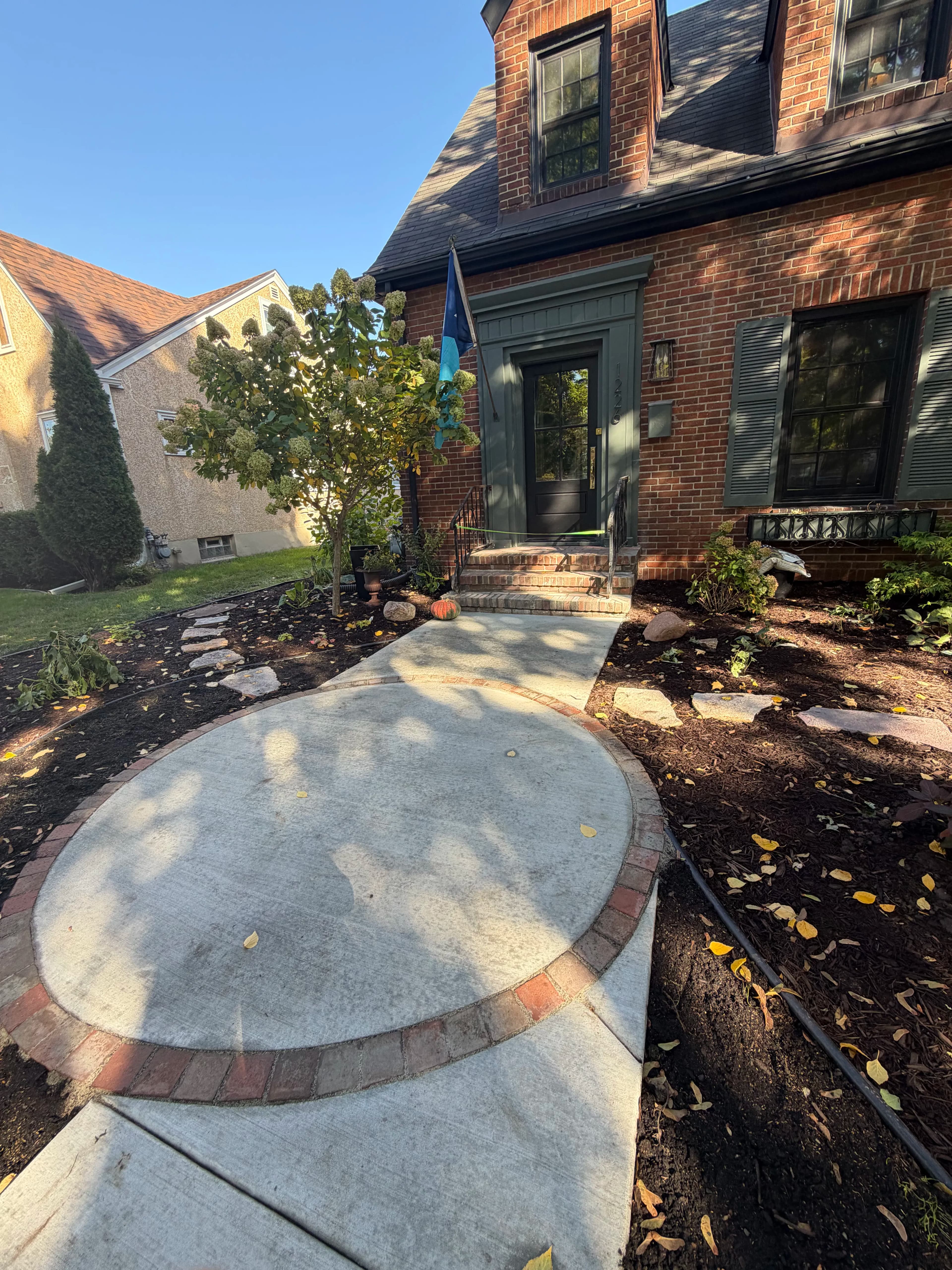 Project Front Yard Landscape Design with Granite Patio and Brick Edging image