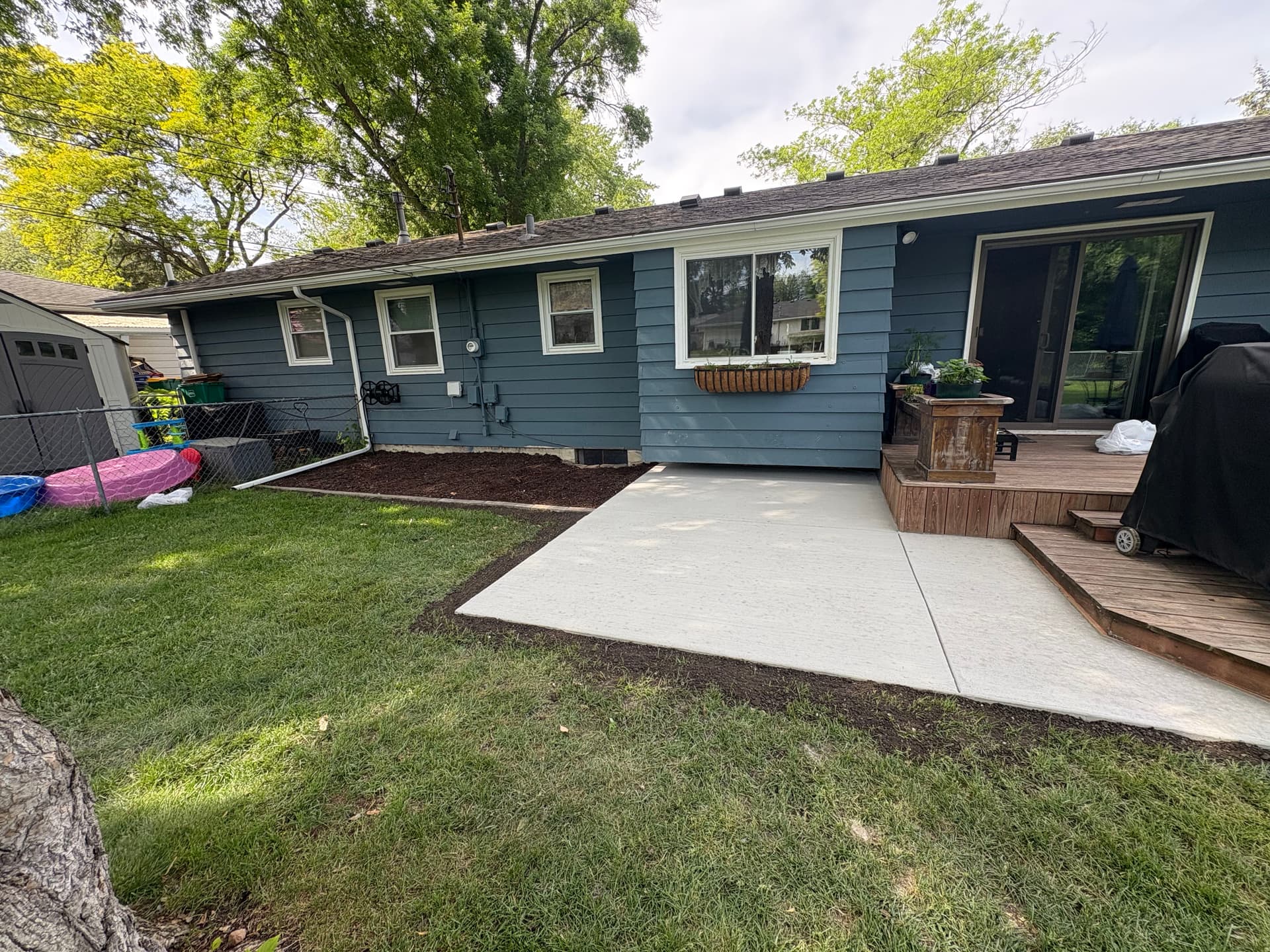 Concrete Patio, Paver Edging, and Fresh Mulch Beds Done Right image